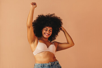 Wall Mural - Beautiful woman with Afro hair dancing happily