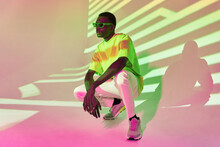 Cool Black Man In Green T Shirt And Sunglasses Posing In Shadows