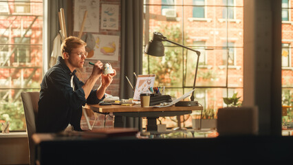 Leinwandbilder - Young Male Artist Working on Custom Made Sneakers in Front of his Laptop Computer in Creative Loft Office Space. Man Drawing on White Shoes. Trendy Design For Fashion Show Concept.