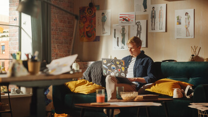 Poster - Teenage Male e-Business Entrepreneur Use Laptop, Does Remote Work. Handsome Man Sitting on the Sofa, Brainstorms Creative Project with Research. Sunny Stylish Loft Apartment Room.