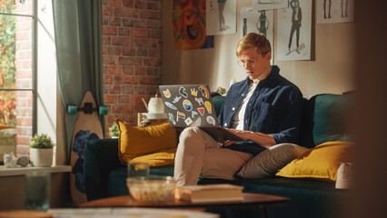 Poster - Portrait of a Handsome Man Sitting on Couch, Using Laptop Computer in Stylish Loft Apartment on Sunny Day. Creative Male Focused, Working on Online Project, Thinking About Future Results.