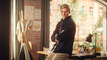 Aufkleber - Portrait of Young Caucasian Man with Blonde Hair and Glasses Posing for Camera in Creative Studio. Talented Male Artist Crosses Arms and Looks at the Camera with Smile. Modern Occupation Concept.