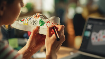 Leinwandbilder - Over the Shoulder View of Young Woman at Home Drawing on Shoes, Working at Home. Girl Using Computer with 3D Model of Stylish Footwear. Hand Made and Craft Concept. Close Up.