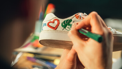 Poster - Close Up of Artist Hand, Holding Marker and Drawing Design on Shoes. Painter Creates Custom Made Sneaker and Makes his Own Product. Millennial People and Startup Company Concept.