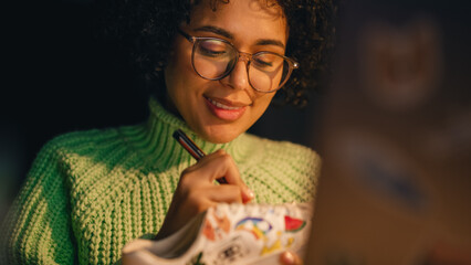 Leinwandbilder - Portrait of Multiracial Teenage Designer Creating New Sneakers in the Evening. Female Artist is Customising Hype Shoes by Adding Own Design. Trends in Footwear Industry Concept.