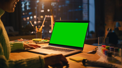 Poster - Close Up View of Brasilian Female Designer Working on Laptop with Green Screen Chromakey on Display. Woman Using Computer Mouse and Creating New Project. Freelance and Millennial People Concept.