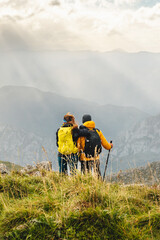 hiker couple on top of a mountain contemplating the mountain range. outdoor sport, hiking and mountain.