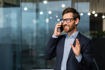 mature businessman in a business suit talking on the phone, the manager is satisfied with the result