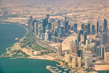 Poster - Aerial view of Doha skyline from airplane. Corniche and modern buildings, Qatar