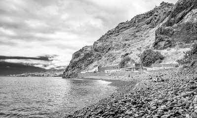 Poster - Madeira, Portugal - September 7, 2022: Tourists enjoy the beach at Ponta do Garajau