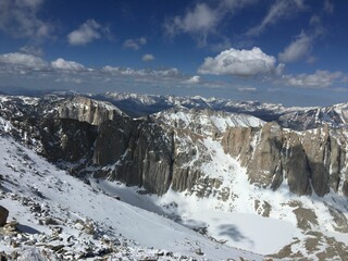 Sticker - Beautiful view of snow-covered mountains against the background of the blue cloudy sky.