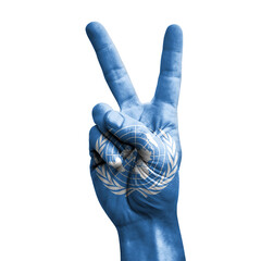 Hand making the V victory sign with flag of united nations