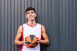 © ADDICTIVE STOCK - Male basketball player with ball against dark background