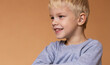 © StasyDolce - A boy with a hearing aids on beige background