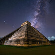 Temple with Mayan pyramid of Kukulcan El Castillo at night with starry sky at archaeological site in Mexico.