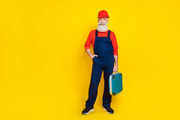 Wall Mural - Full size photo of pensioner artisan workman standing with mechanical tool box isolated on bright color background