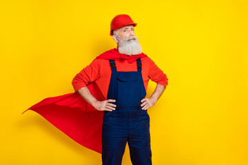 Photo of confident cool old guy dressed uniform overall red hardhat mantle ready help empty space isolated yellow color background