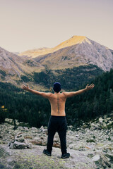 Sticker - Boy looking at an impressive mountain landscape from the top