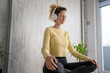 © Miljan Živković - one woman doing guided meditation yoga self care practice at home