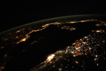 Wall Mural - Aerial space view, cities light up the night. Nighttime view from space of the Mediterranean Sea from north Africa to southern Europe. Elements of this image furnished by NASA.