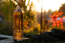 An Image Of A Smoky Quartz Crystal Tower Taken In Late Evening With Golden Sunlight Reflecting Off The Tip Of The Crystal. 