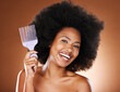Beauty, hair and afro and black woman and comb for self care, natural and freedom. Happy, smile and untangling with portrait of African girl model and curly hair for luxury and confidence