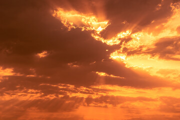 Sticker - Crepuscular rays of the sun streaming through dark clouds in the sky.