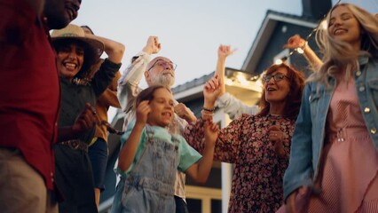 Wall Mural - Portrait of a Senior Happy Couple Dancing Together with Children and Friends at a House Garden Party Event. Young and Elderly People Having Fun on a Warm Summer Evening. Slow Motion Footage.