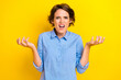 Photo of stressed angry lady wear blue shirt rising arms screaming isolated yellow color background