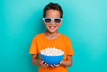 Photo Of Pretty Cute Little Guy Dressed Orange T-shirt Sunglass Eating Pop Corm Isolated Teal Color Background
