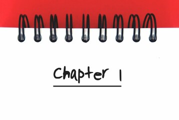 white paper note with text written Chapter 1 , concept of author or writer start writing first chapter of book e-book, novel or freelance writer job