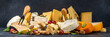 © ricka_kinamoto - Different sorts of cheese set. Cheese platter with various cheese, with grapes, nuts, cheese knife and spices, black tiled background copy space