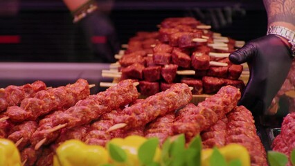 Wall Mural - Close up turkish kebab lamb meat on skewers in supermarket. Meat prepared for grill in butchers shop.