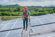 Engineer man or worker checking the operation of the system solar panels or solar cells on roof,Renewable energy source,Eco technology for electric power.