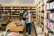 © AntonioDiaz - College student looking at the novels at the bookstore