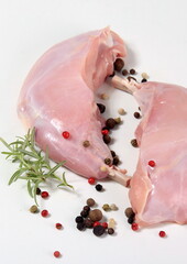 Wall Mural - raw rabbit legs with bone with peppercorns on a white background