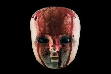 Wall Mural - Creepy bloody doll head isolated on black background with clipping path