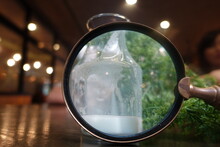 White Milk In A Large Glass Bottle Shines With A Magnifying Glass.