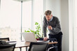 © gzorgz - Tired businessman using laptop at the office