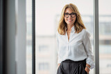Fototapeta  - Portrait of smiling businesswoman in office
