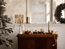 Christmas Composition On The Vintage Shelf In The Living Room Interior With Mock Up Poster Frame, Beautiful Decoration, Big Window, Christmas Tree, Candles, Stars, Gifts, Light And Elegant Accessories