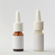different kind of nasal spray bottles mockup, brown glass and white plastic containers of medical moisturizer for flu and allergies, pharmaceutical aerosol with pump on a gray background, blank label