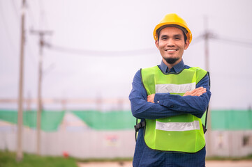 Wall Mural - Asian Engineer standing outdoor on site construction posting confident , Engineer construction happy job success with in target planning