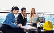 © Jack Tamrong - Group of architect and construction engineerworking together at rooftop office