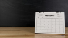 February Calendar On Wood Desk White Background.
 Feb 2023 Agenda Concept.