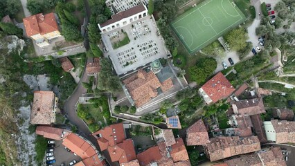 Wall Mural - Aerial footage of the city of Nago-Torbole in Trentino, Italy, with an old cathedral