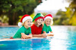 © famveldman - Christmas vacation on tropical island. Xmas kids.
