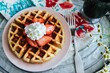 High angle shot of strawberry waffles and coffee in a tray