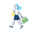 ショッピングバッグを持って歩く若い女性