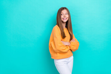 Sticker - Photo of beautiful brown hair teen girl wear trendy color sweater folded arms looking mockup opening shopping mall isolated on cyan color background